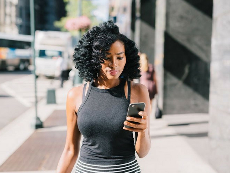 black woman checking phone