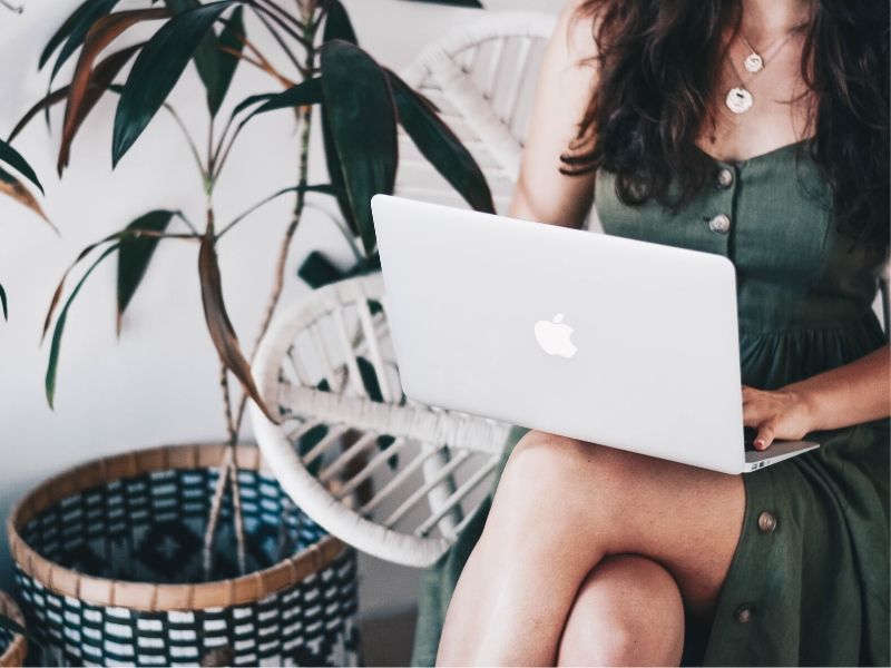 woman typing on macbook pro