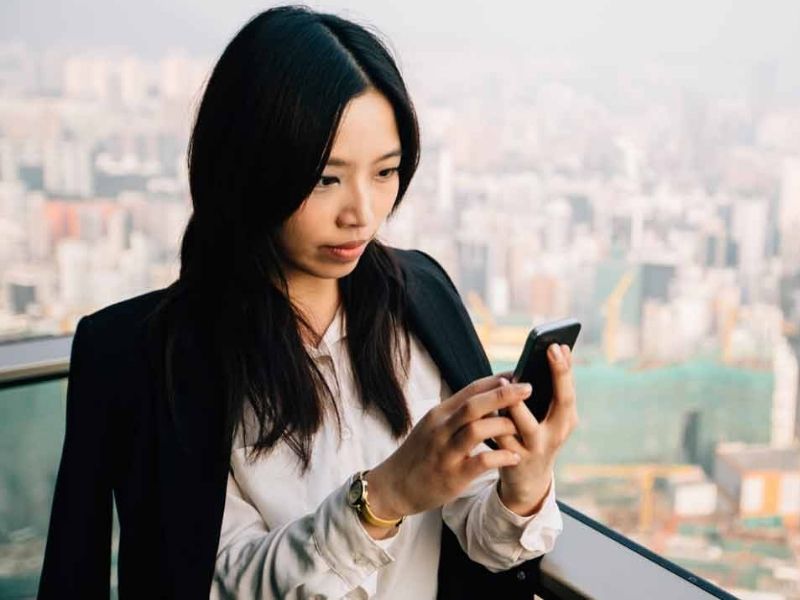 Asian businesswoman using her cellphone